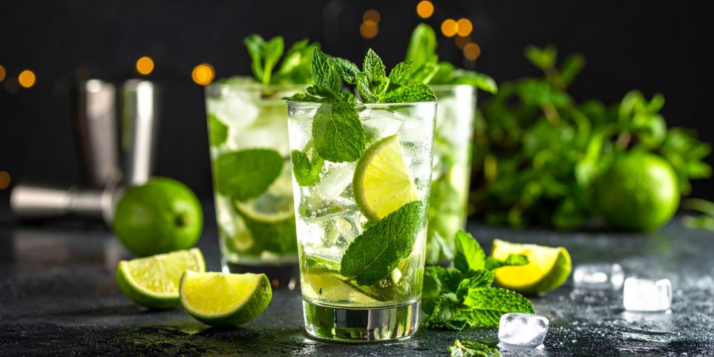 Close-up of three Virgin Mojitos with fresh mint and lime garnish