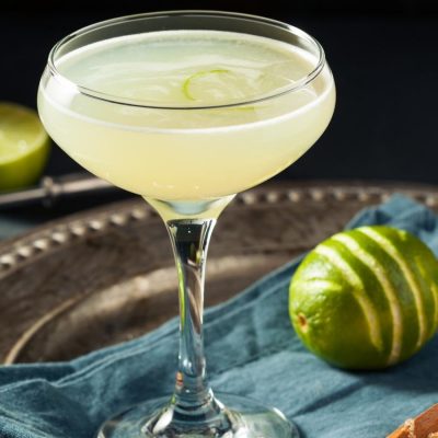 Refreshing vodka Gimlet in a coupe glass on a silver tray