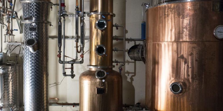 Origins of Gin - A glimpse inside a distillery, showcasing the origins of gin production.
