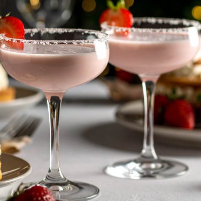 Close-up of two Strawberry Shortcake Daiquiris served with shortcakes, whipped cream and strawberry jam