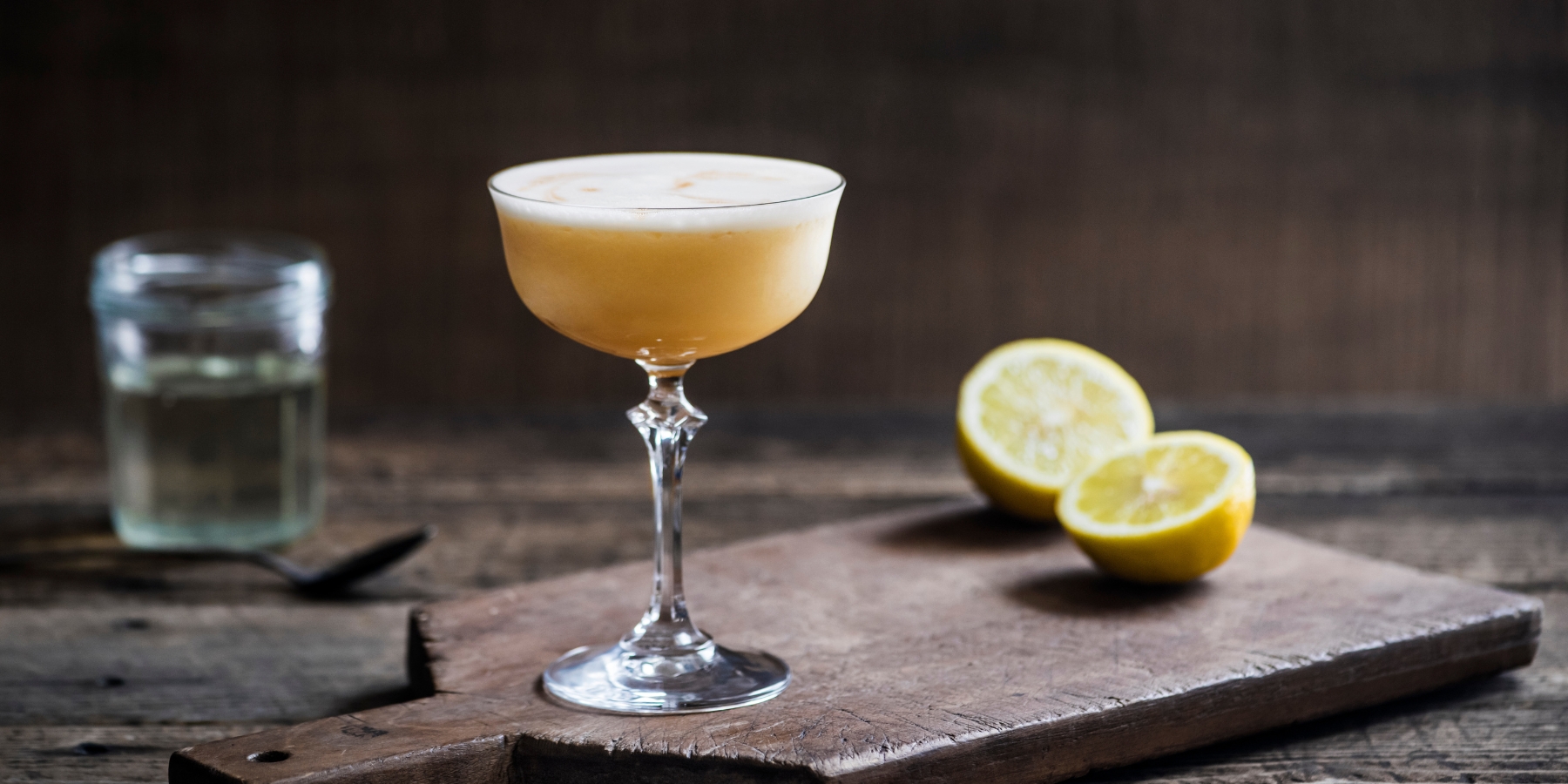 A Bourbon Sour with bitters garnish served in a coupe glass