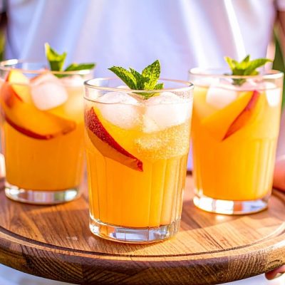 person with tray of summer cocktails