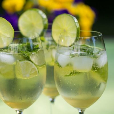 Front view of Hugo Spritz Cocktail garnished with lime wheels