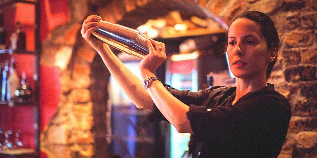 High-quality Cobbler shaker being used in a bar by a bartender.