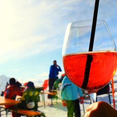 Aperol cocktail with ski slopes in the background