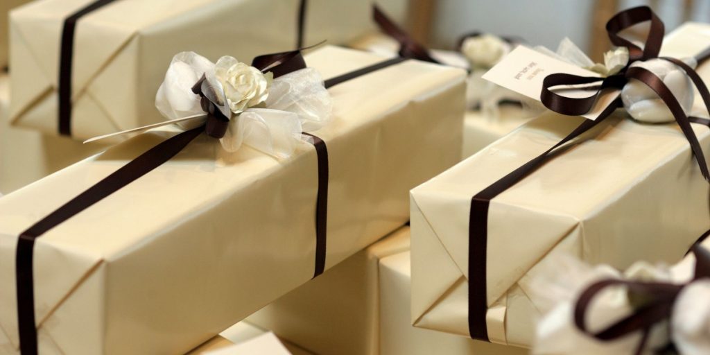 A table full of wrapped wedding gifts.