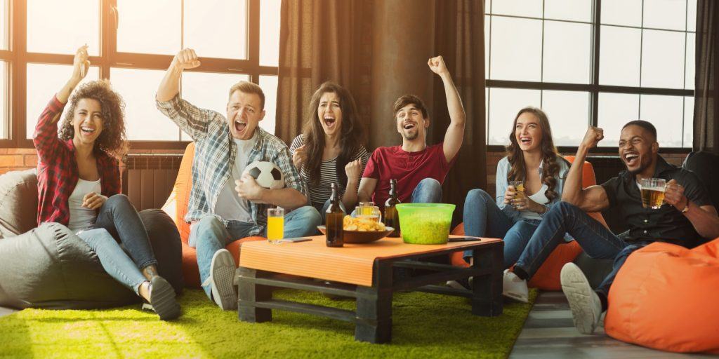 Soccer fans watching the game in a lounge 
