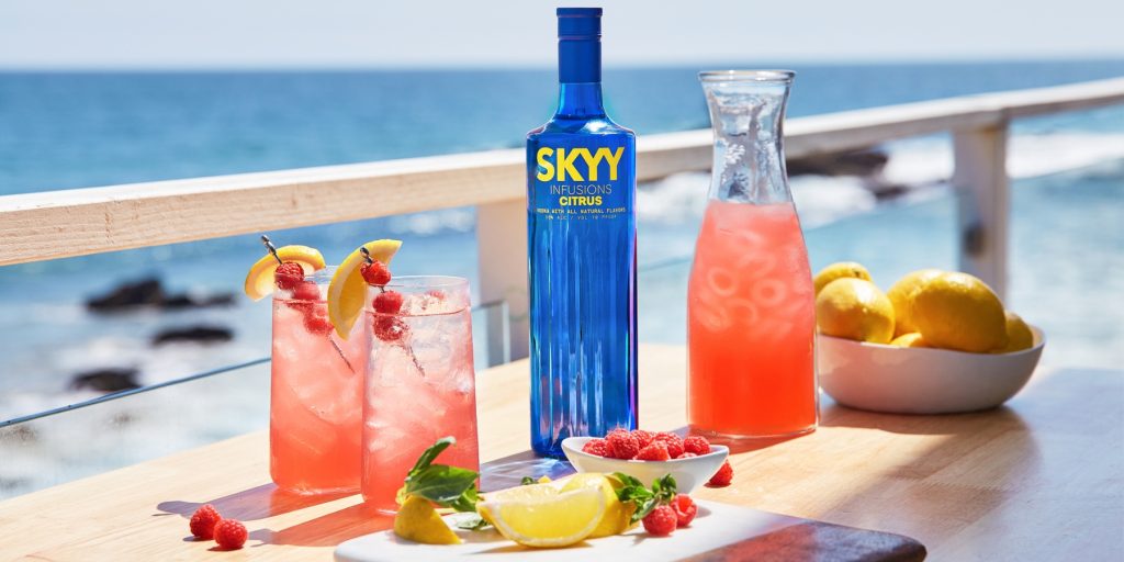 Two Citrus Raspberry Lemonades with raspberry and lemon garnish served oceanside 