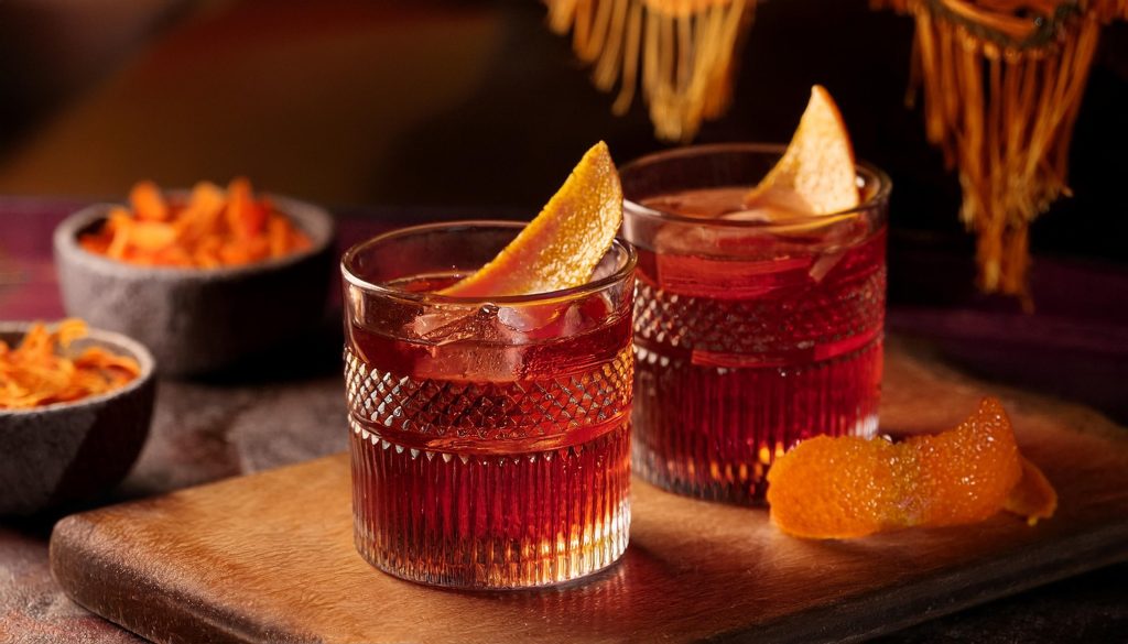 Two Montelobos Mezcal Negronis with orange peel garnish