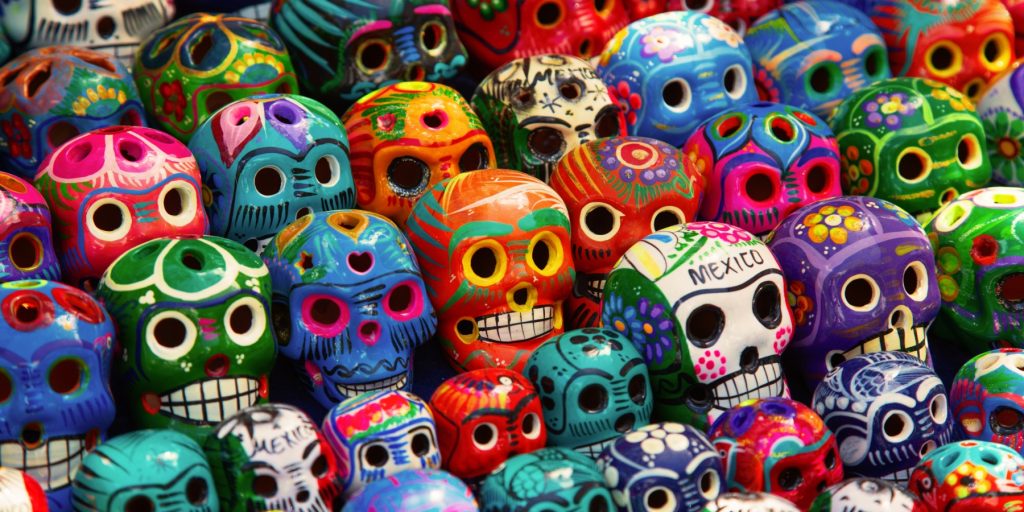 Close up of a collection of colorful ceramic sugar skulls