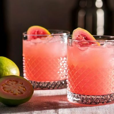 Two Guava Mezcal Margaritas with fresh Guava garnish