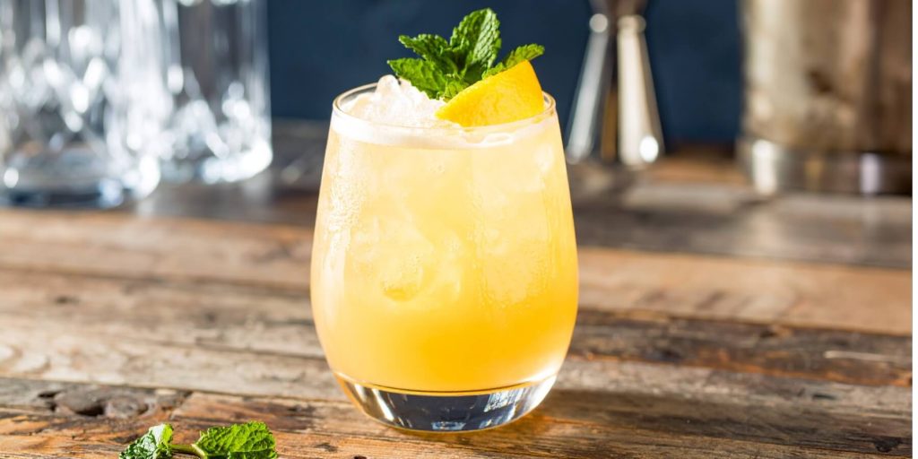 An Drunken Helmsman in a rocks glass, garnished with a sprig of mint