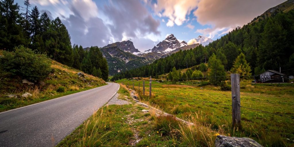 A road and landscape shot of the Italian countryside with mountains.